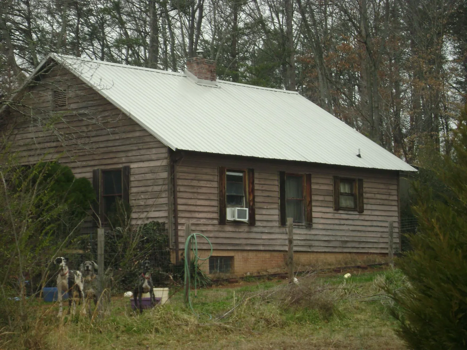 White metal roof on an old wood sided farmhouse, from a Metal Roof Installation job in Reno